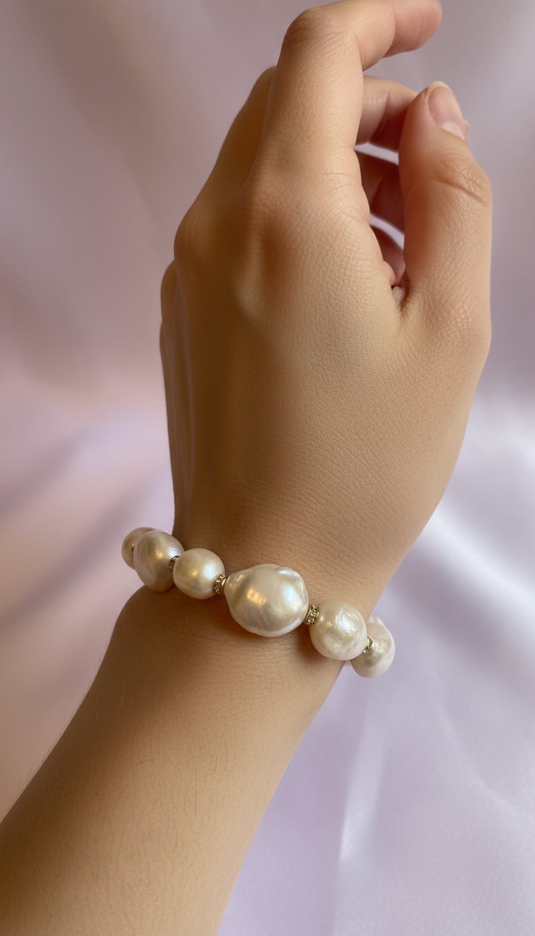 Pearl bracelet on a light pink background
