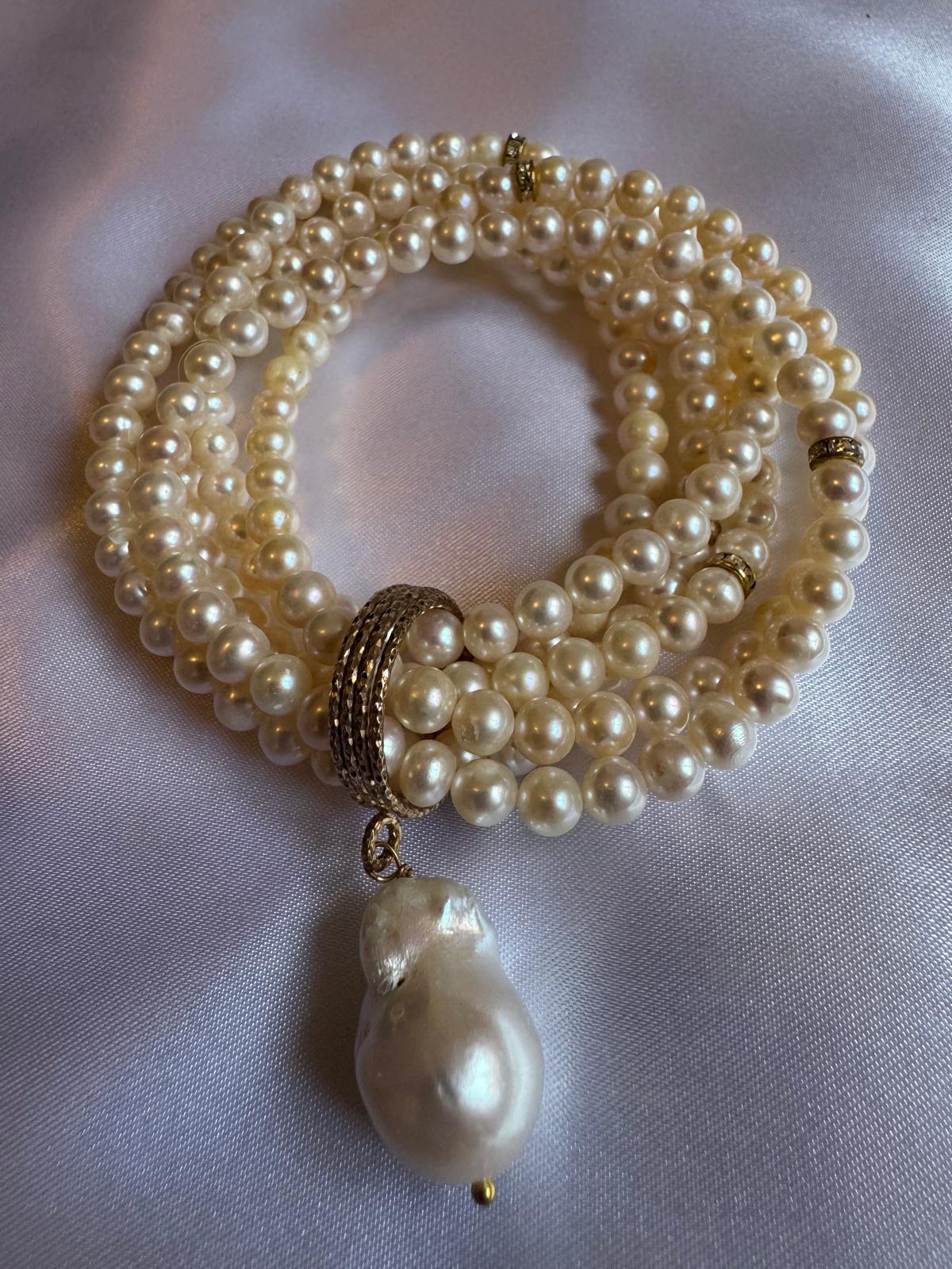 Multi strand, stretchy pearl bracelet  with pendant.