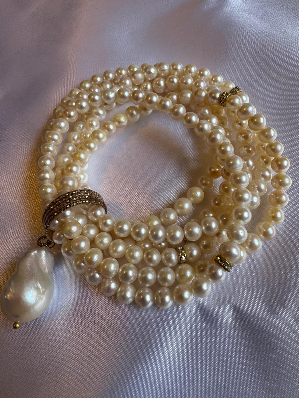 Multi strand, stretchy pearl bracelet  with pendant.