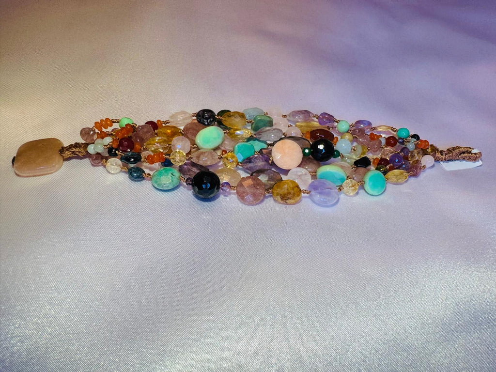 Multi strand bracelet with various hard stones.