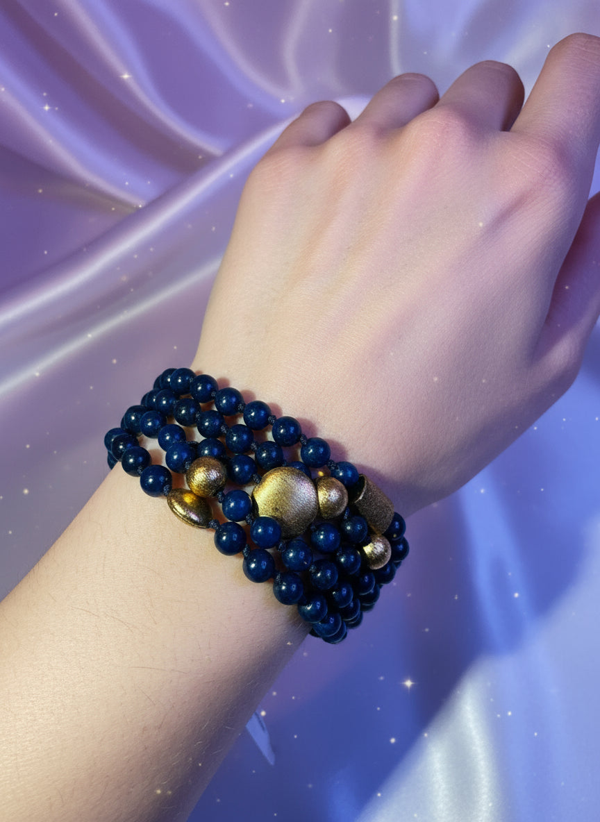 Blue beaded bracelet with gold accents and a golden centerpiece