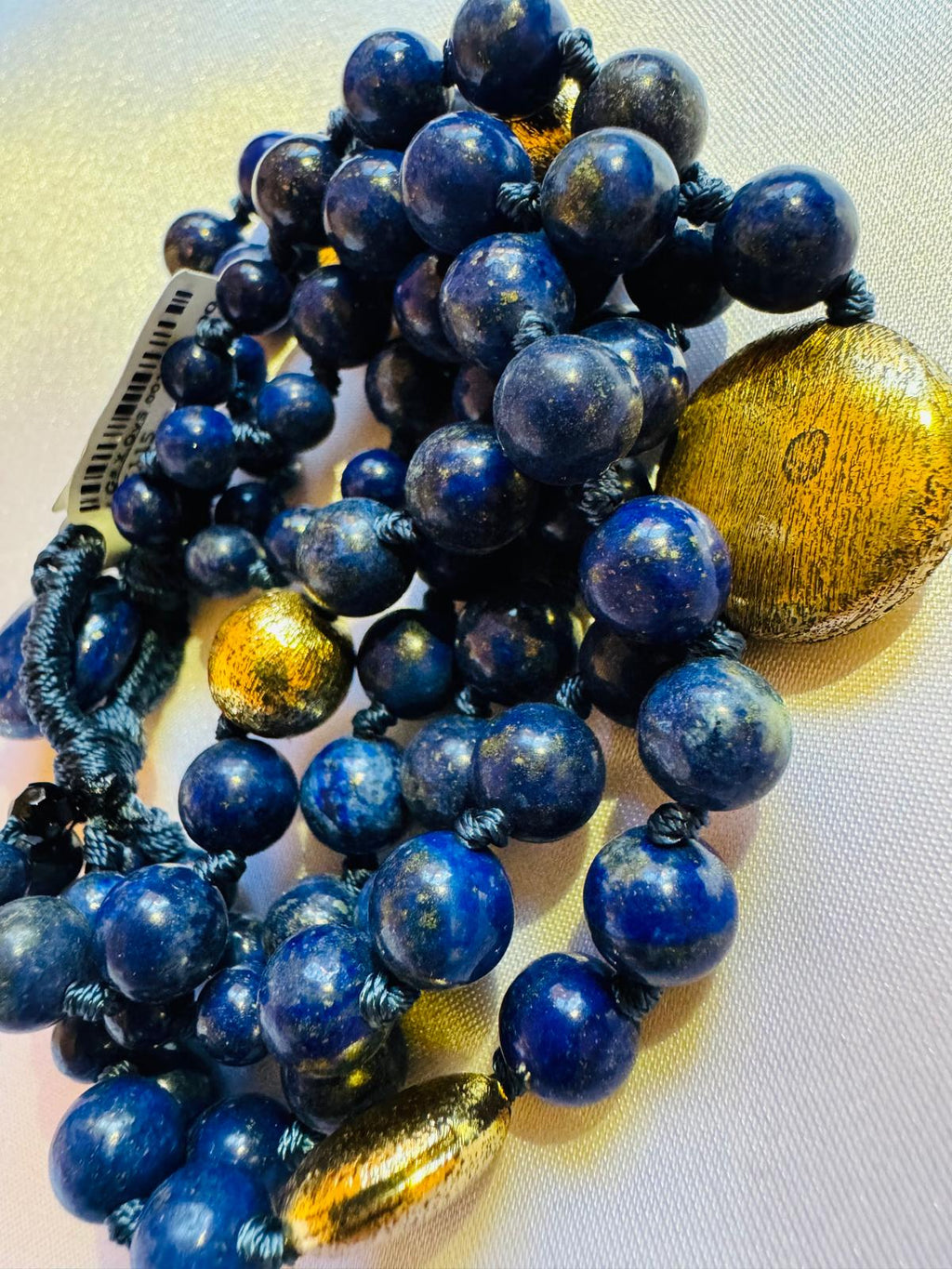 Multi strand lapis lazuli and nugget bracelet with a golden centerpiece