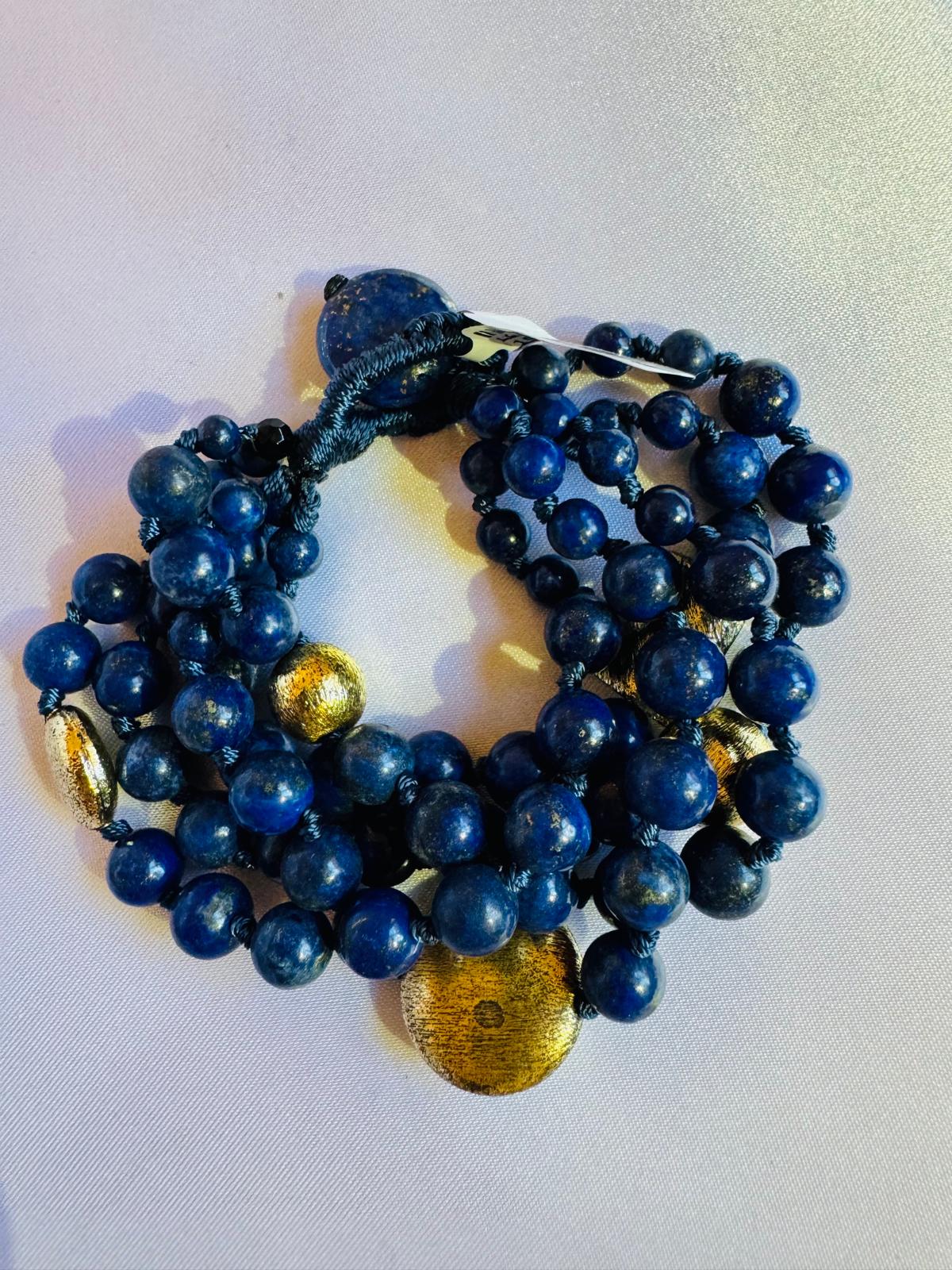 Multi strand lapis lazuli and nugget bracelet with a golden centerpiece