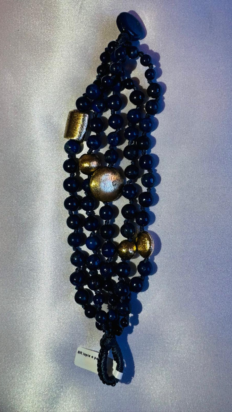 Multi strand lapis lazuli and nugget bracelet with a golden centerpiece