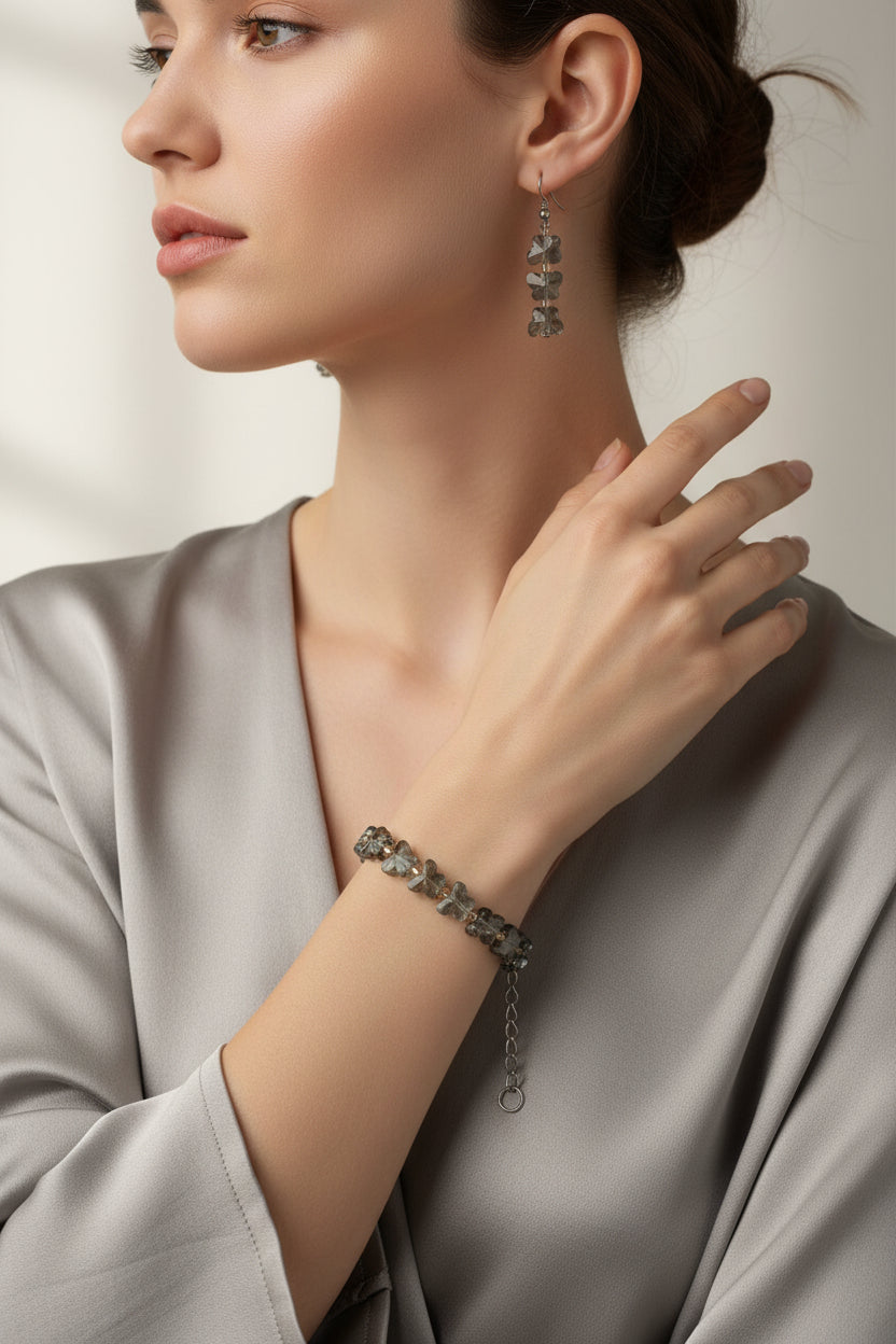Bracelet and earrings set on a textured white surface