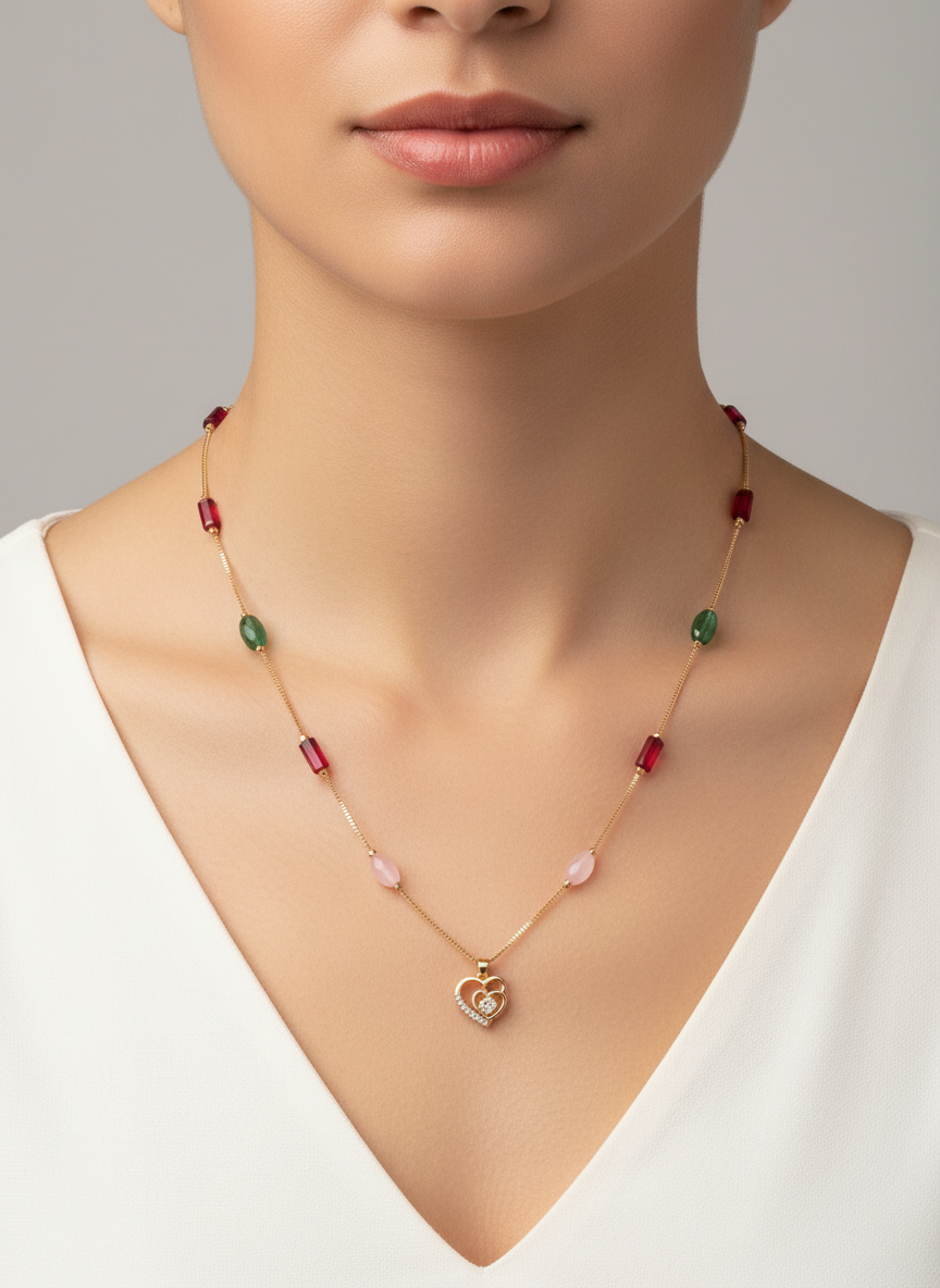 Elegant dual heart golden pendant with golden chain and red green and pink stone accents