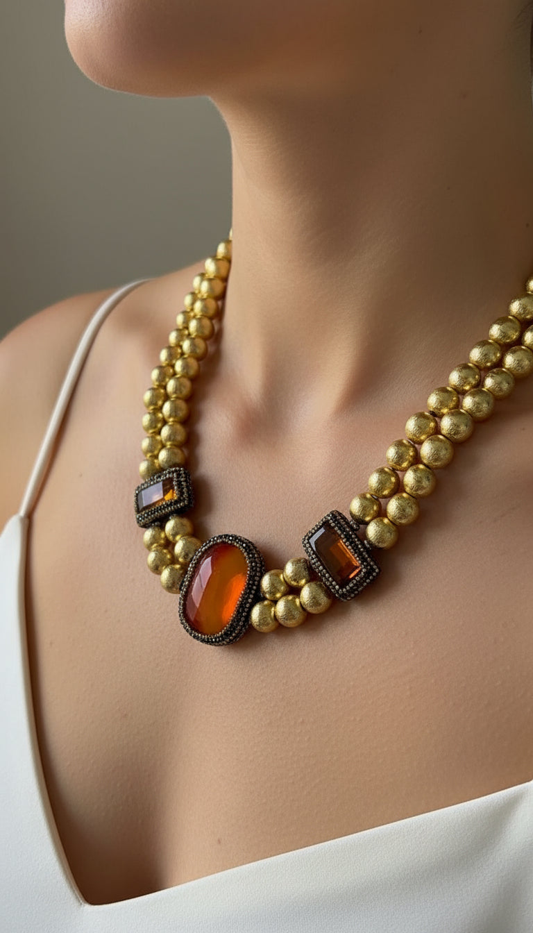Golden Pearl necklace with large Red and Orange gemstones.