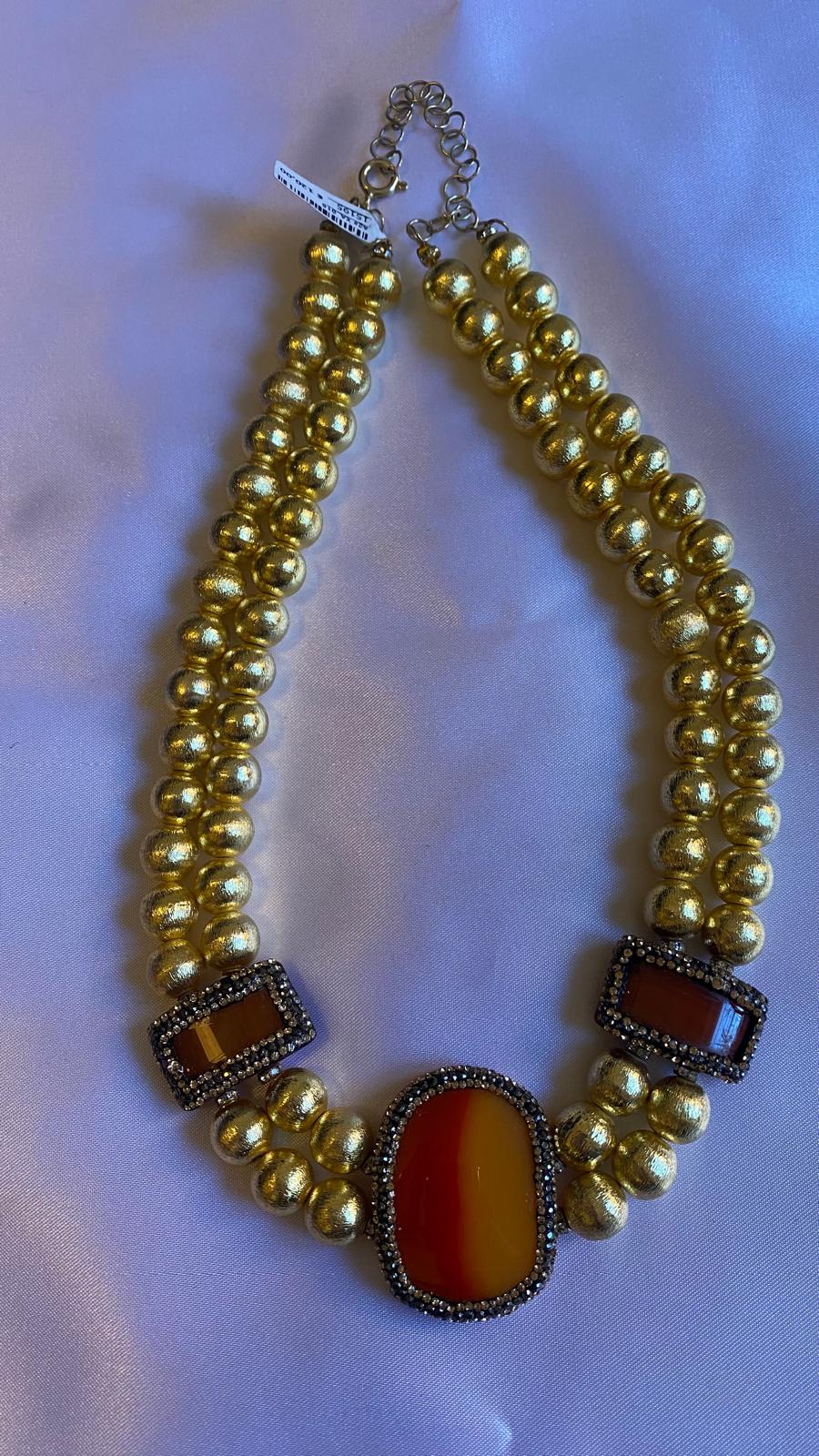 Golden Pearl necklace with large Red and Orange gemstones.