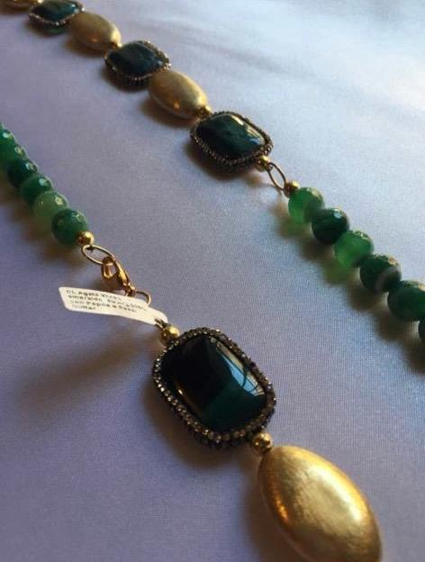 Necklace with stripped green Tourmaline beads and gold accents.