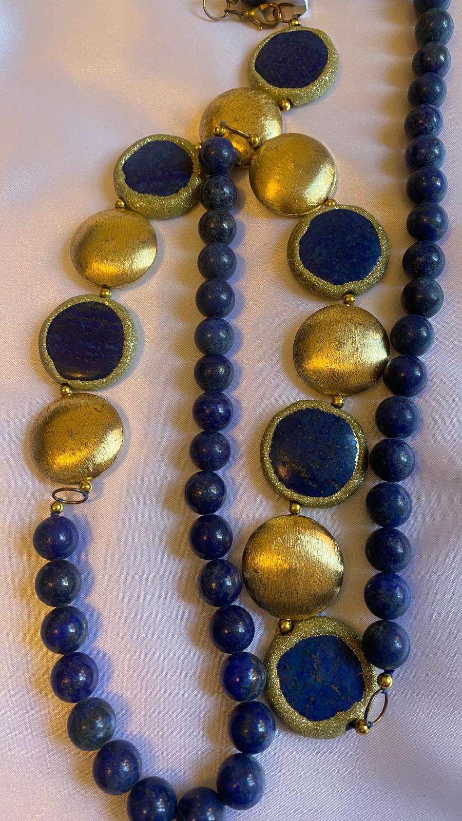 Necklace with blue beads and gold circular accents