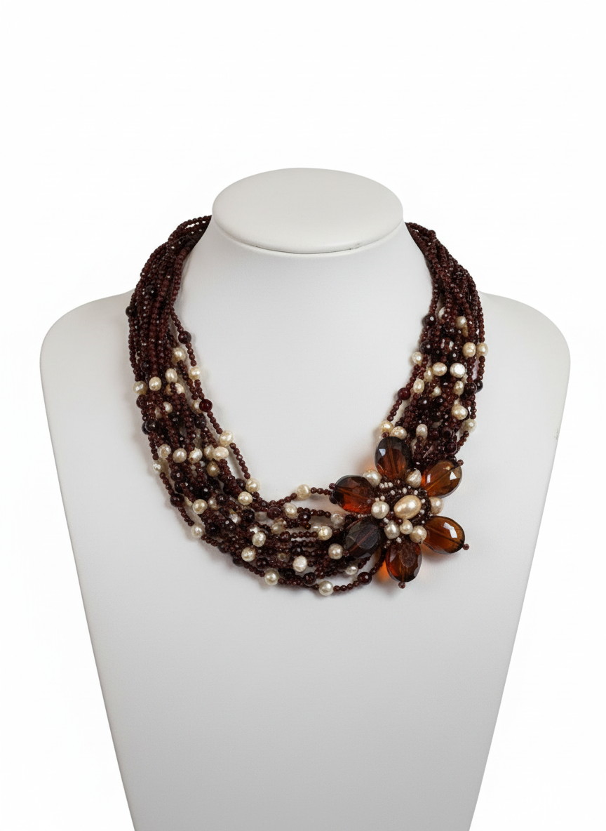 Necklace with brown and amber beads on a white mannequin bust