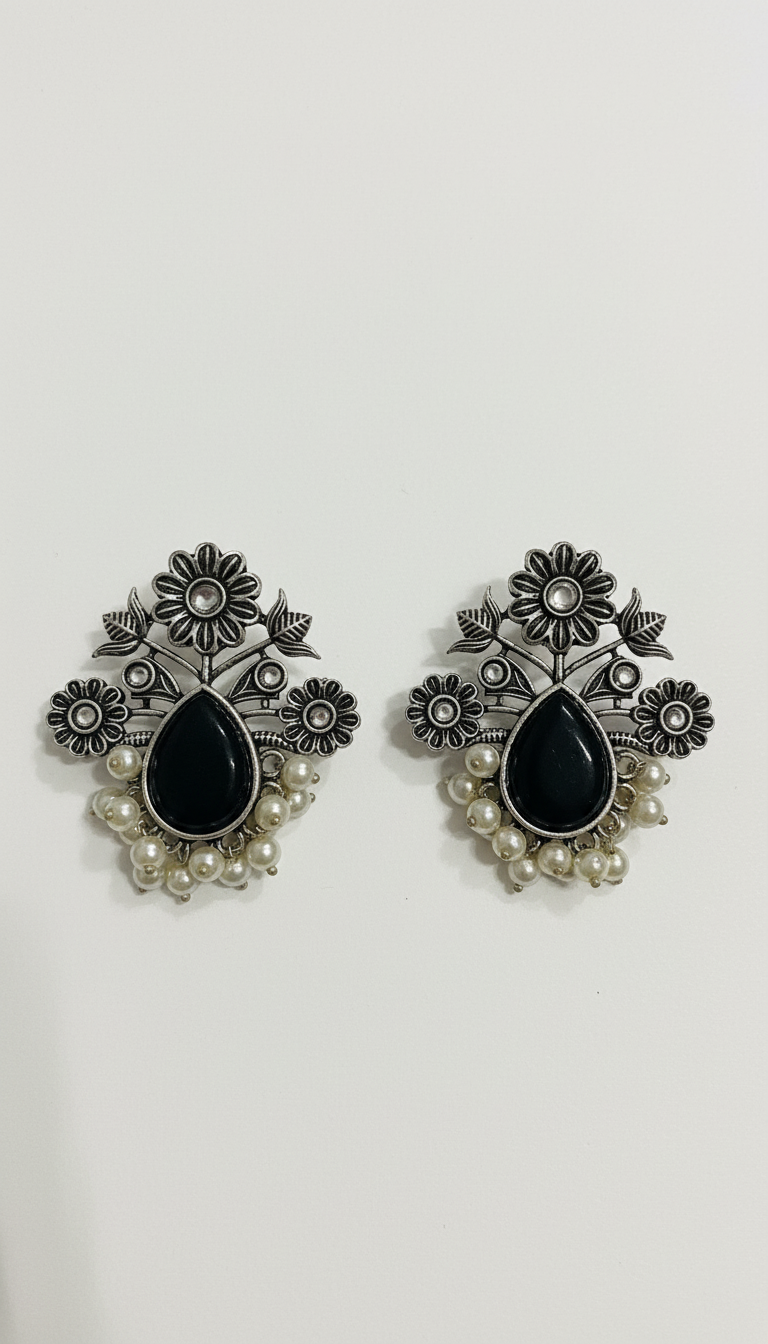 Puces d'oreilles en argent allemand oxydé, ornées d'une pierre centrale noire et de perles.