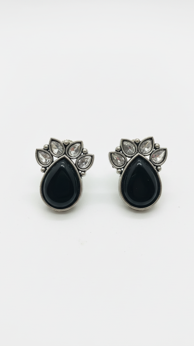 Pair of black teardrop earrings with silver accents on a white background
